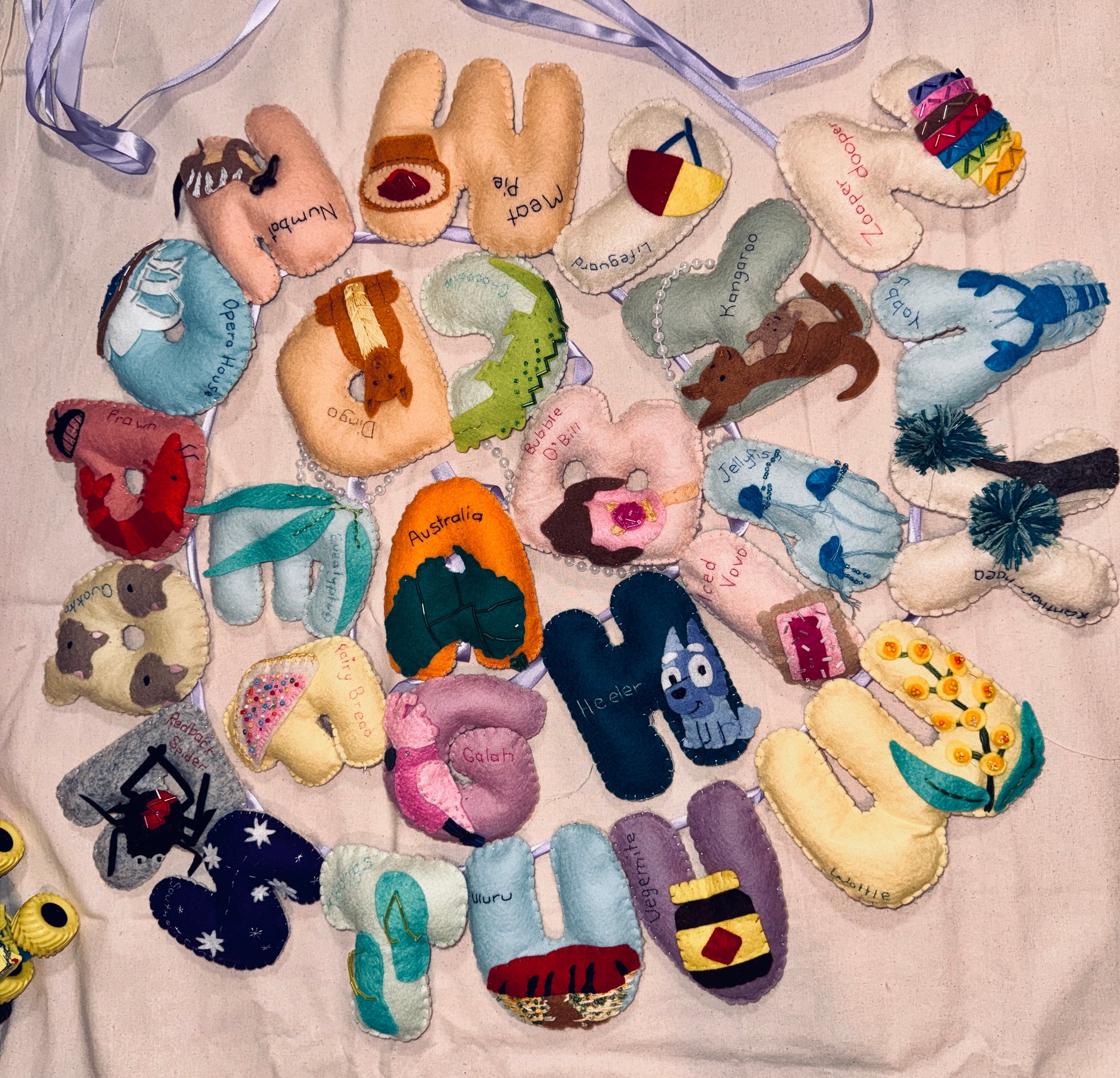 Collection of colorful felt letters and shapes on a light background